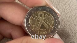 Translation: Rare commemorative 2 Euro coin RF 2014 AIDS in very good condition.